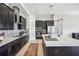 Modern kitchen with dark cabinetry, quartz countertops, and stainless steel appliances at 12818 Boggy Creek Dr, Riverview, FL 33579