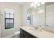 Clean bathroom with single vanity, shower/tub combo, and updated countertop at 12818 Boggy Creek Dr, Riverview, FL 33579