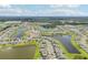 Aerial view of community with lake and homes at 12818 Boggy Creek Dr, Riverview, FL 33579