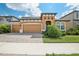 Two-story house with a two-car garage, and a nicely landscaped yard at 12818 Boggy Creek Dr, Riverview, FL 33579