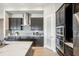 Modern kitchen with dark cabinetry, quartz countertops, and stainless steel appliances at 12818 Boggy Creek Dr, Riverview, FL 33579