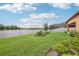 Backyard oasis with pond view, lush landscaping, and screened patio at 12818 Boggy Creek Dr, Riverview, FL 33579