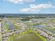 Aerial view of community with lake and homes at 12818 Boggy Creek Dr, Riverview, FL 33579