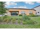 Home's backyard showcasing manicured lawn and landscaping at 12818 Boggy Creek Dr, Riverview, FL 33579