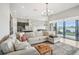 Spacious living room with large windows and sliding doors leading to a patio with lake views at 12818 Boggy Creek Dr, Riverview, FL 33579