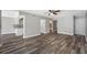 Bright living room with wood-look floors and access to a balcony at 1655 S Highland Ave # E223, Clearwater, FL 33756