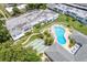 Community pool and shuffleboard courts with surrounding landscaping and building at 1655 S Highland Ave # E223, Clearwater, FL 33756