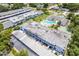 Aerial view of building exteriors, parking, and community amenities at 1655 S Highland Ave # E223, Clearwater, FL 33756