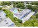 Aerial view of the community pool, building, and parking at 1655 S Highland Ave # E223, Clearwater, FL 33756