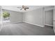 Spacious bedroom with grey carpet and large window at 1655 S Highland Ave # E223, Clearwater, FL 33756