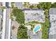 An aerial view of the community pool, building, and surrounding landscape at 1655 S Highland Ave # E223, Clearwater, FL 33756