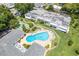 Community pool and shuffleboard courts with surrounding landscaping at 1655 S Highland Ave # E223, Clearwater, FL 33756