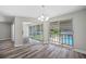Dining room with wood-look floors and sliding doors to balcony at 1655 S Highland Ave # E223, Clearwater, FL 33756