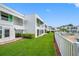 Community pool area with lawn and white fence at 1655 S Highland Ave # E223, Clearwater, FL 33756