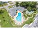Aerial view of community pool, shuffleboard, and surrounding buildings at 1655 S Highland Ave # E223, Clearwater, FL 33756