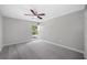Bright bedroom with gray carpeting and large window at 1655 S Highland Ave # E223, Clearwater, FL 33756