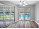 Bright dining area with sliding glass doors offering pool and landscape views at 1655 S Highland Ave # E223, Clearwater, FL 33756