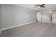 Spacious bedroom with gray carpet and ceiling fan at 1655 S Highland Ave # E223, Clearwater, FL 33756