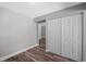 Bright bedroom with double door closet and wood-look flooring at 1655 S Highland Ave # E223, Clearwater, FL 33756