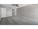 Spacious bedroom with gray carpeting and ceiling fan at 1655 S Highland Ave # E223, Clearwater, FL 33756