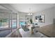 Dining area with pool view, staged with table and chairs at 1655 S Highland Ave # E223, Clearwater, FL 33756
