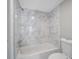 Bathroom with marble-look tiled shower and tub at 1655 S Highland Ave # E223, Clearwater, FL 33756