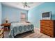 Bright bedroom with double bed, dresser, and wood flooring at 11314 Misty Isle Ln, Riverview, FL 33579