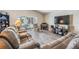 Living room with hardwood floors, comfortable seating and sliding glass doors leading to a patio at 11314 Misty Isle Ln, Riverview, FL 33579