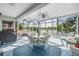 Spacious screened patio overlooking lake with seating area at 11314 Misty Isle Ln, Riverview, FL 33579