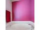 Bathroom with a garden tub and pink walls at 11314 Misty Isle Ln, Riverview, FL 33579