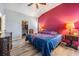 Main bedroom with a king-size bed, walk-in closet, and an accent wall at 11314 Misty Isle Ln, Riverview, FL 33579