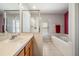 Bathroom with a soaking tub, vanity, and walk-in shower at 11314 Misty Isle Ln, Riverview, FL 33579