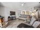 Bright living room with hardwood floors, comfortable seating, and a view into the kitchen at 11314 Misty Isle Ln, Riverview, FL 33579