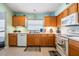 Kitchen with light wood cabinets, white appliances, and ample counter space at 11314 Misty Isle Ln, Riverview, FL 33579