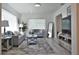 Bright living room with gray sofas and a large TV at 1921 W Grace St, Tampa, FL 33607