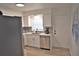 Modern kitchen with white cabinets, stainless steel appliances, and a view of the dining area at 1921 W Grace St, Tampa, FL 33607