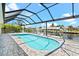Inviting pool area with covered patio, overlooking canal at 5217 Forbes Ter, Port Charlotte, FL 33981
