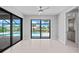 Gathering room with sliding glass doors opening to a pool and canal view at 5217 Forbes Ter, Port Charlotte, FL 33981