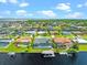 Aerial view of a canal-front community with numerous houses and pools at 5217 Forbes Ter, Port Charlotte, FL 33981