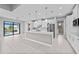 Modern kitchen with stainless steel appliances and white cabinetry, island, and pool view at 5217 Forbes Ter, Port Charlotte, FL 33981