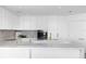 Modern kitchen with white cabinets and marble island at 2912 W Santiago St # 2104, Tampa, FL 33629
