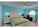 Bedroom with light teal walls, a plush bed, and a workspace at 8818 Bay Pointe Dr # 108, Tampa, FL 33615