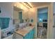 Bathroom with teal vanity, shower/tub combo, and a view to bedroom at 8818 Bay Pointe Dr # 108, Tampa, FL 33615