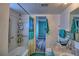 Main bathroom with teal accents, shower/tub, and double vanity at 8818 Bay Pointe Dr # 108, Tampa, FL 33615