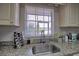 Kitchen sink with granite countertop and a window overlooking the water at 8818 Bay Pointe Dr # 108, Tampa, FL 33615
