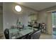 Dining area with glass table and chairs, adjacent to kitchen at 8818 Bay Pointe Dr # 108, Tampa, FL 33615