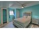 Bedroom with light teal walls, plush bed, and large closet at 8818 Bay Pointe Dr # 108, Tampa, FL 33615