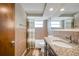 Well-lit bathroom with granite vanity, bathtub, and shower at 5404 Flora Ave, Holiday, FL 34690