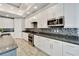 Modern kitchen with white cabinets, granite countertops, and stainless steel appliances at 567 Bimini Bay Blvd, Apollo Beach, FL 33572