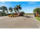 Gated entrance to a residential community, featuring palm trees and well-manicured landscaping at 567 Bimini Bay Blvd, Apollo Beach, FL 33572